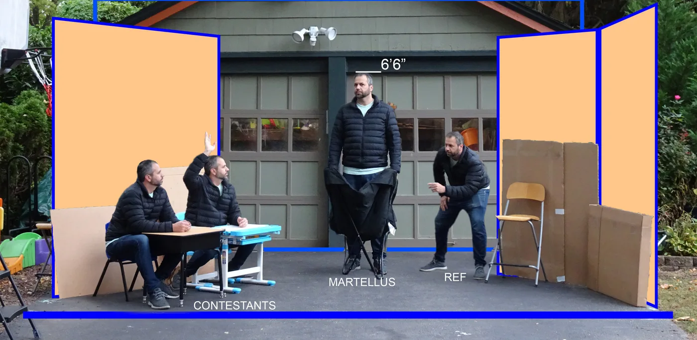 Brad&rsquo;s driveway, marked out as the Dos Equis stage: cardboard and orange flats standing in for the set walls, Brad composited into all four positions with the blue stage plot drawn over the top